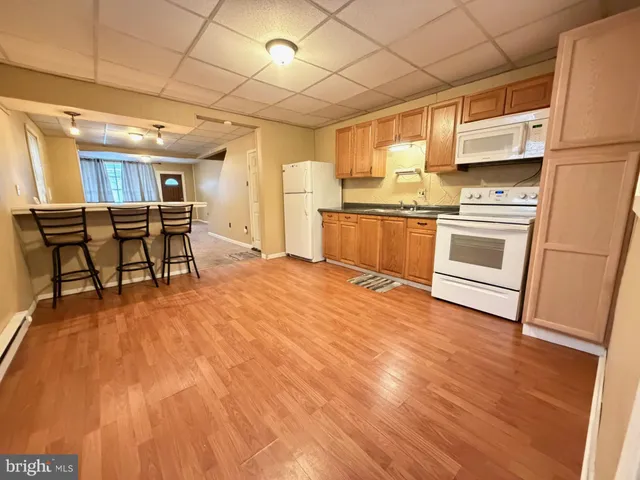a kitchen with a sink appliances and cabinets
