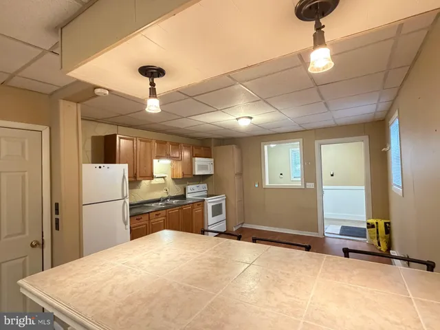 a large kitchen with cabinets and stainless steel appliances
