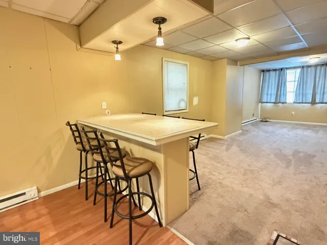 a view of a dining room with furniture and window
