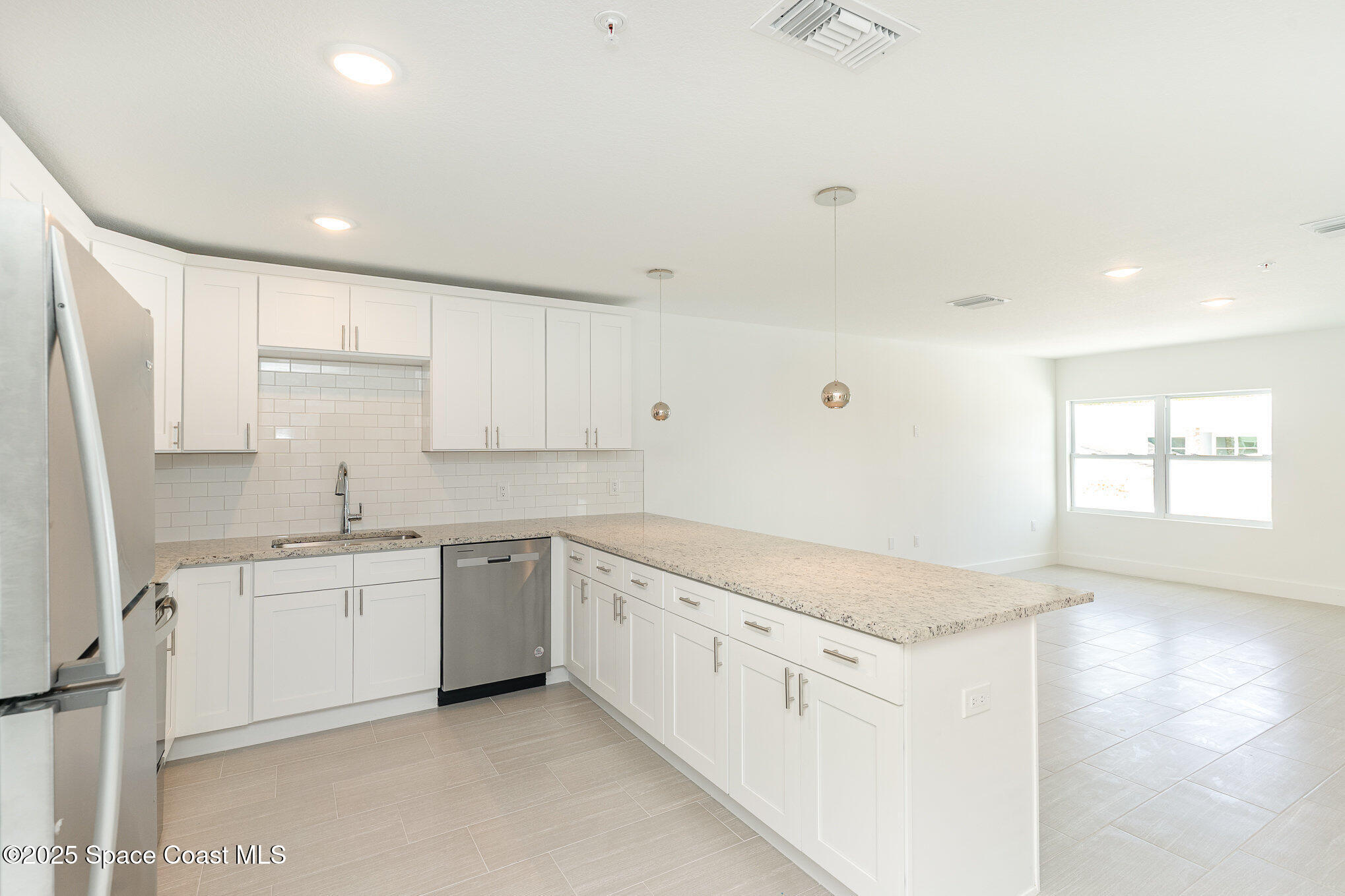 1635 Par Street Northeast, Unit 2202 Palm Bay, FL 32905 - Photo 9 of 45 a kitchen with granite countertop a sink and white cabinets