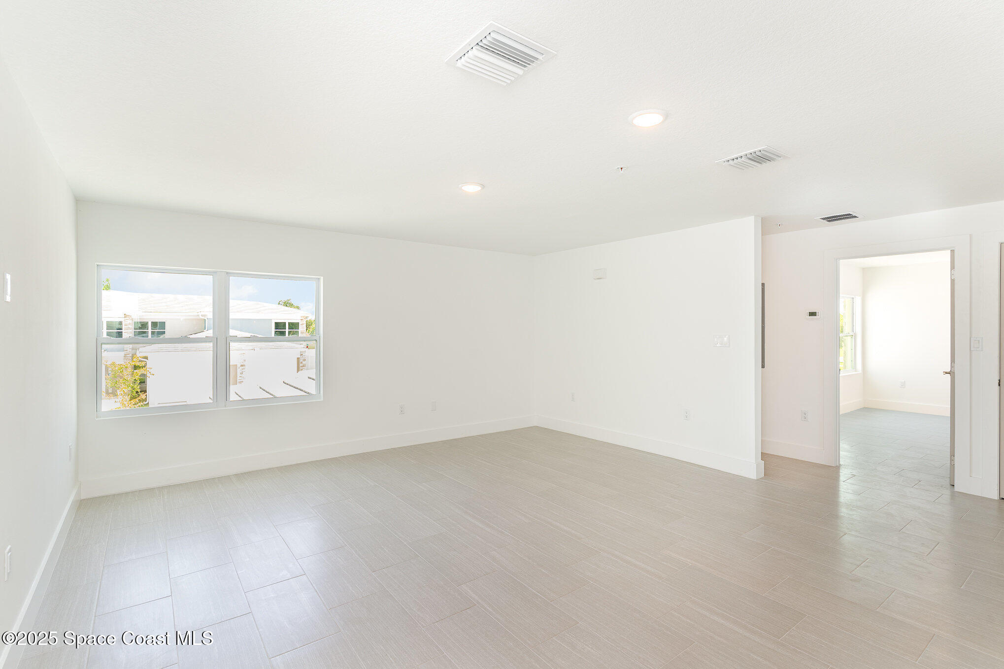 1635 Par Street Northeast, Unit 2202 Palm Bay, FL 32905 - Photo 4 of 45 an empty room with a empty space and windows
