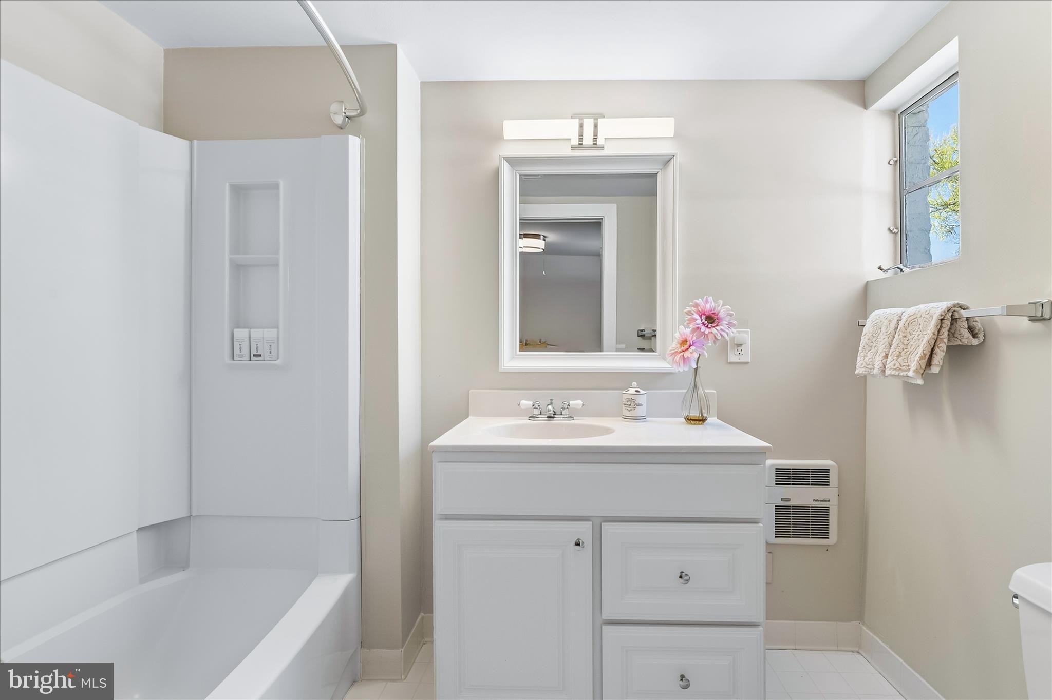 225 East 2nd Street Frederick, MD 21701 - Photo 69 of 125 a bathroom with a sink a mirror and a bathtub