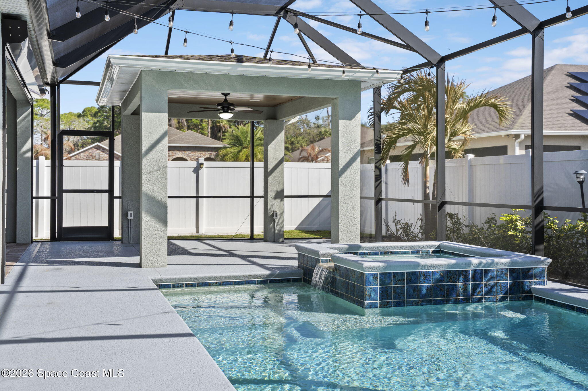 4835 Hebron Drive Merritt Island, FL 32953 - Photo 29 of 53 a backyard of a house with a fountain swing table and chairs