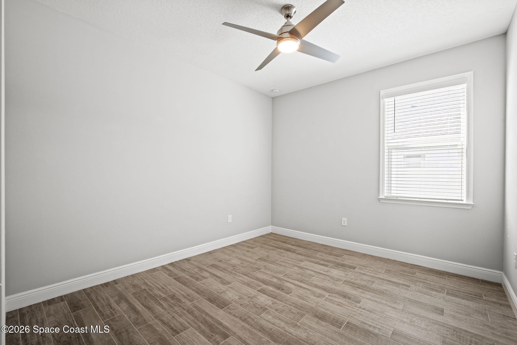 4835 Hebron Drive Merritt Island, FL 32953 - Photo 39 of 53 an empty room with a window and ceiling fan