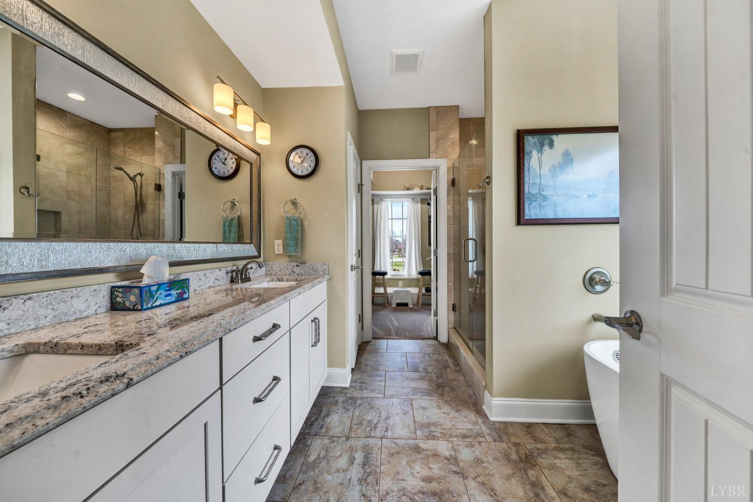 1333 Lynbrook Road Rustburg, VA 24588 - Photo 30 of 53 a spacious bathroom with a granite countertop sink mirror vanity and a toilet