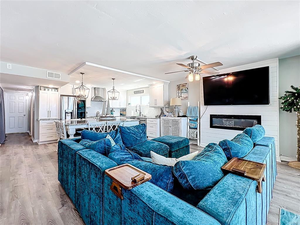 14146 Gulf Boulevard, Unit 3A Madeira Beach, FL 33708 - Photo 12 of 29 a living room with fireplace furniture and a flat screen tv