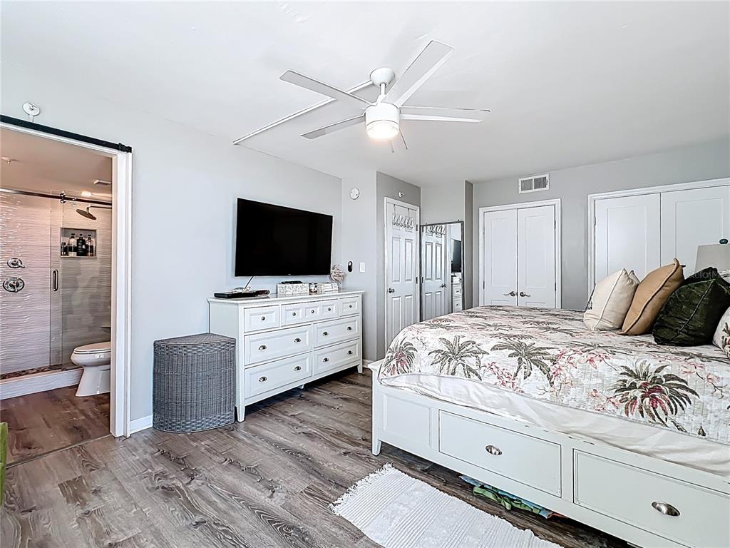 14146 Gulf Boulevard, Unit 3A Madeira Beach, FL 33708 - Photo 17 of 29 a bed room with a bed a television and dresser