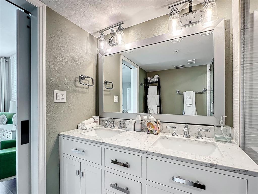 14146 Gulf Boulevard, Unit 3A Madeira Beach, FL 33708 - Photo 19 of 29 a bathroom with a sink double vanity and a mirror