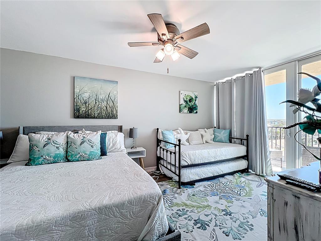 14146 Gulf Boulevard, Unit 3A Madeira Beach, FL 33708 - Photo 21 of 29 a bedroom with a bed and wooden floor