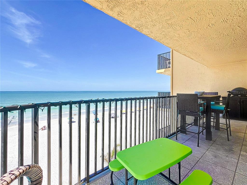 14146 Gulf Boulevard, Unit 3A Madeira Beach, FL 33708 - Photo 5 of 29 a view of a balcony with table and chairs