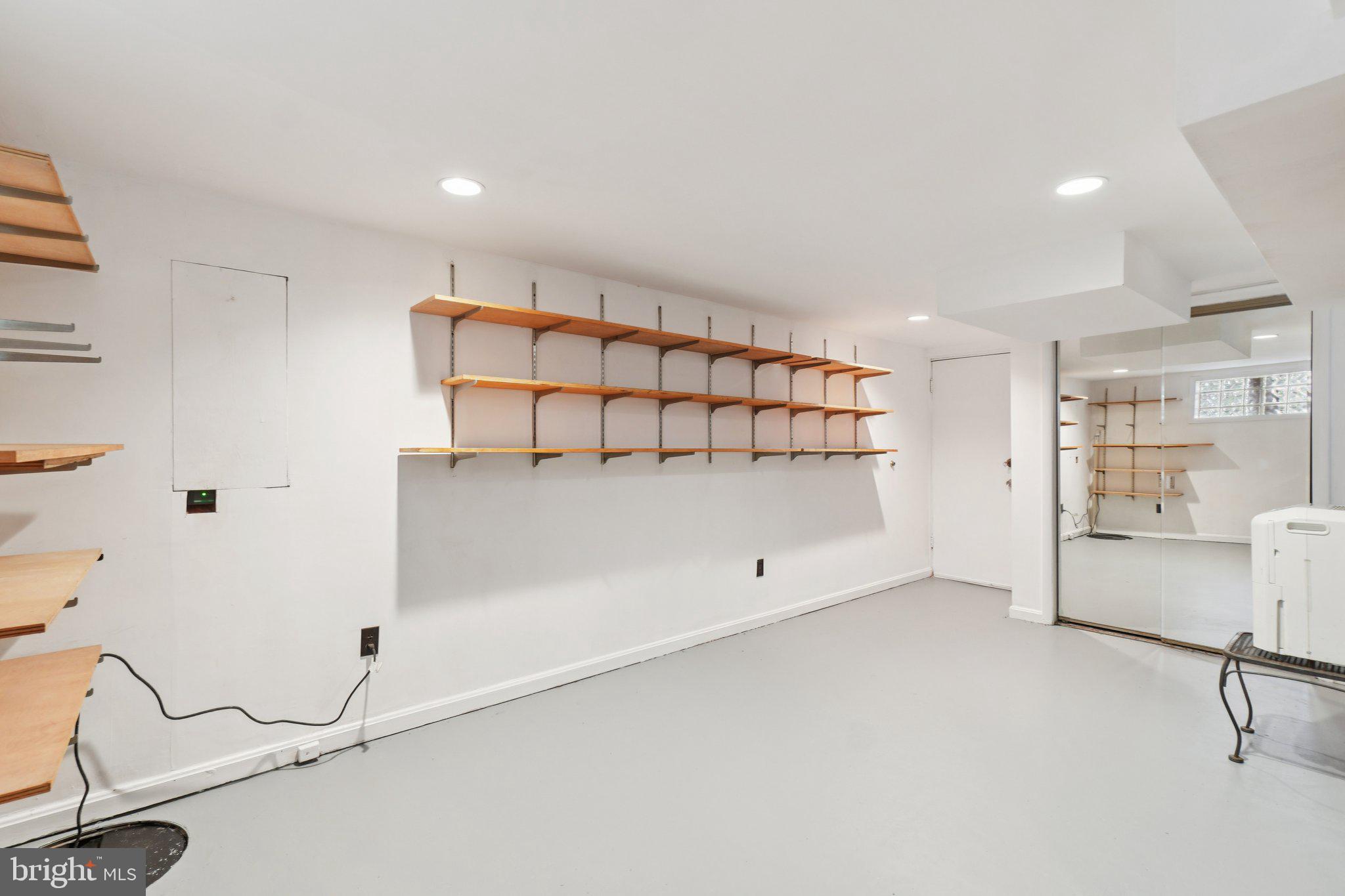 5008 44th Street Northwest Washington, DC 20016 - Photo 18 of 26 a room with a wooden floor and white walls