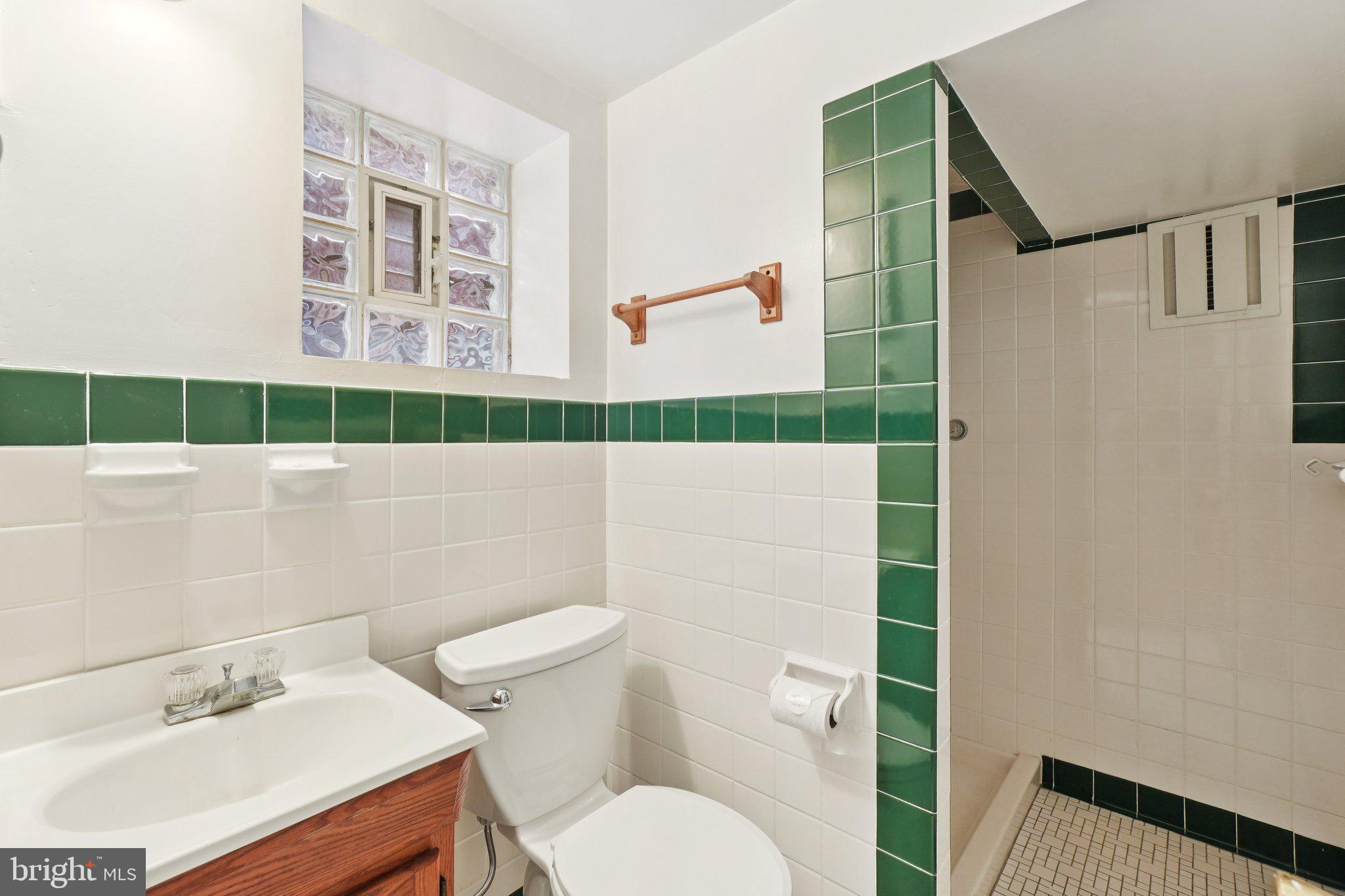 5008 44th Street Northwest Washington, DC 20016 - Photo 20 of 26 a bathroom with a sink toilet and shower