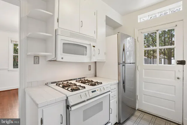a kitchen with a stove and a refrigerator