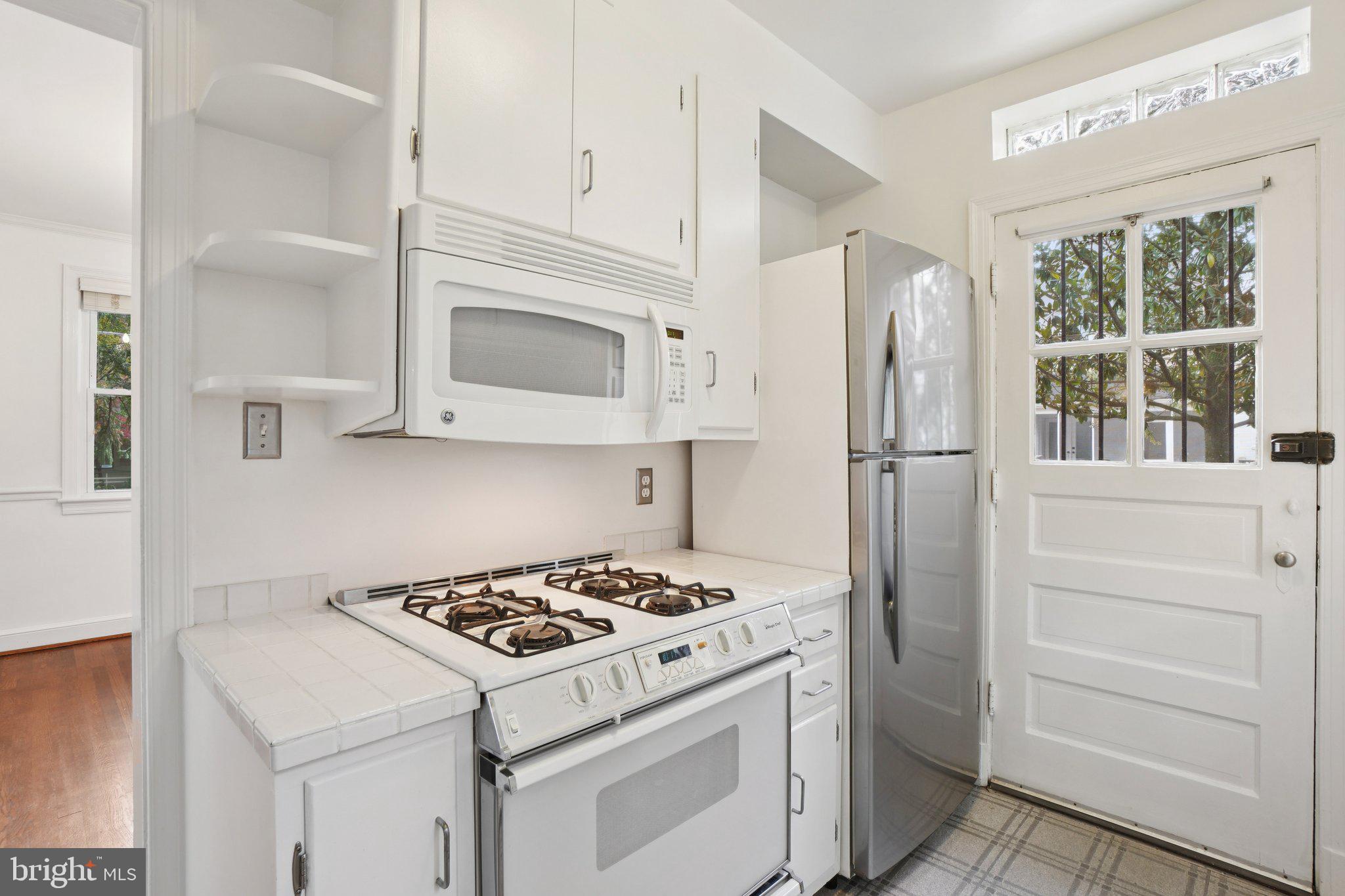 5008 44th Street Northwest Washington, DC 20016 - Photo 8 of 26 a kitchen with a stove and a refrigerator