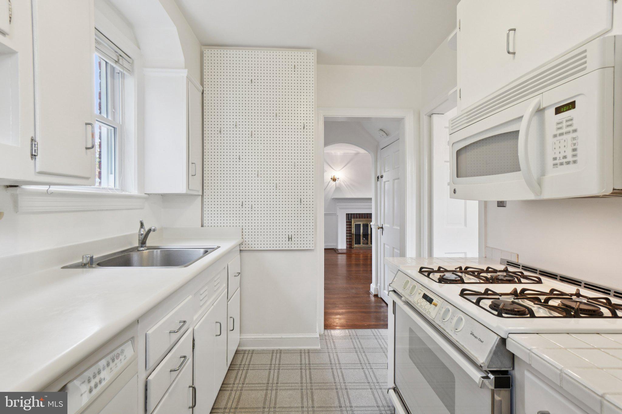 5008 44th Street Northwest Washington, DC 20016 - Photo 9 of 26 a kitchen with a sink stove and cabinets