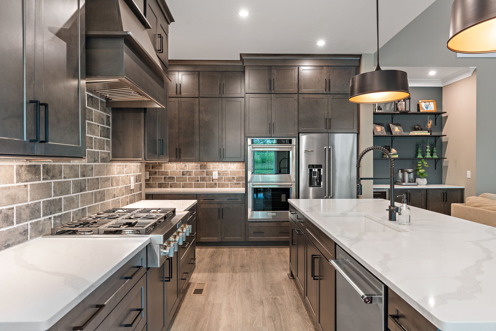 7276 Murrel Drive Franklin, TN 37064 - Photo 13 of 62 a kitchen with stainless steel appliances a sink a stove and a wooden floors
