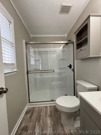 a bathroom with a toilet and a shower