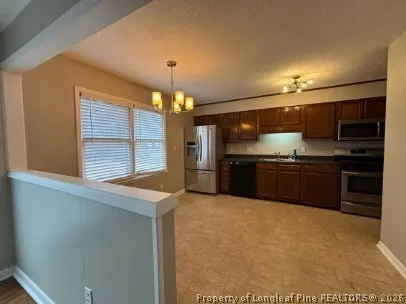 a kitchen with stainless steel appliances a sink and a refrigerator