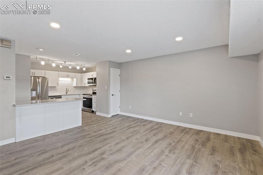 4435 Hunting Meadows Circle Colorado Springs, CO 80916 - Photo 4 of 15 Living room toward kitchen