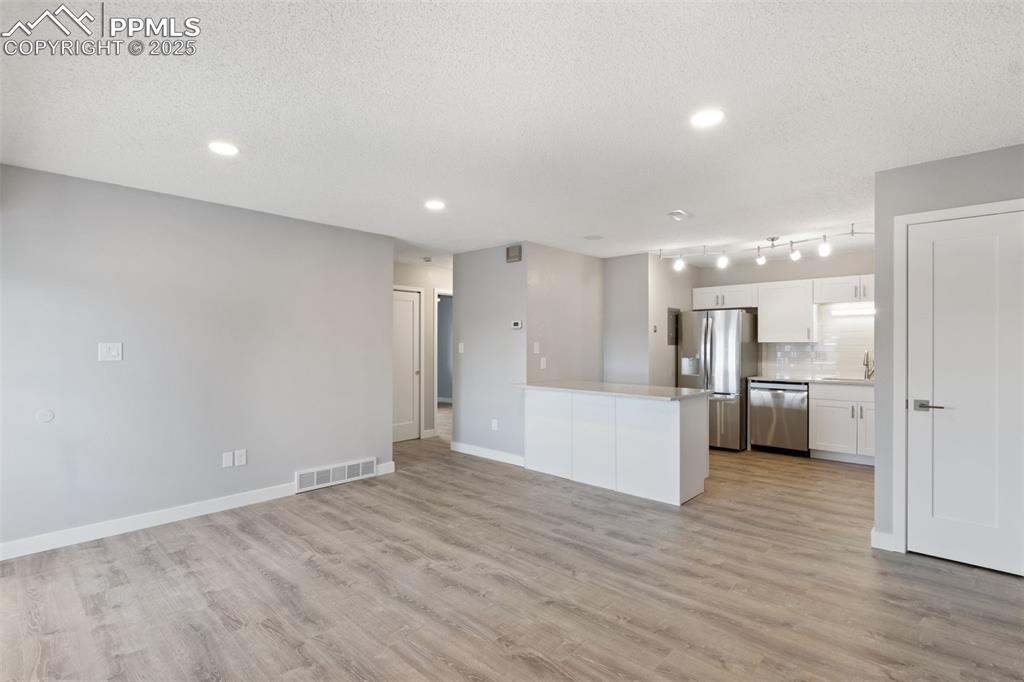 4435 Hunting Meadows Circle Colorado Springs, CO 80916 - Photo 5 of 15 Living Room Toward Kitchen