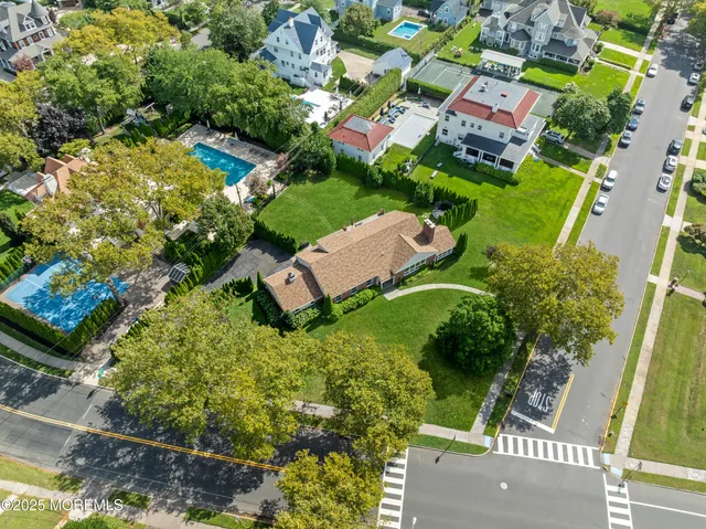 an aerial view of residential houses with outdoor space and street view