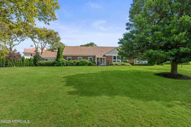 a view of a big yard with a house in the background