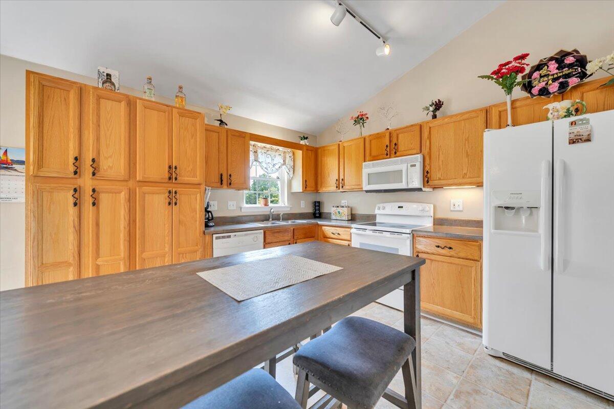 4751 Westvale Road Northeast Roanoke, VA 24019 - Photo 9 of 30 a kitchen with stainless steel appliances granite countertop a refrigerator a sink dishwasher and a stove with wooden floor