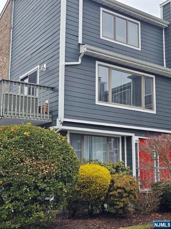 58 Main Street, Unit 29 Little Ferry, NJ 07643 - Photo 2 of 5 a front view of a house with garden