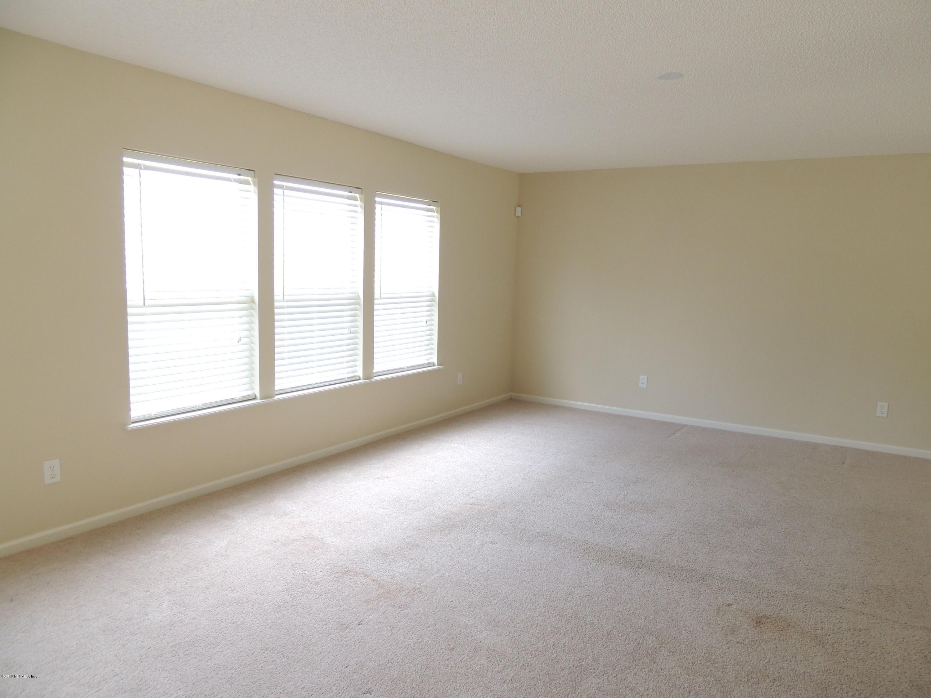 1179 Morning Light Road Jacksonville, FL 32218 - Photo 3 of 17 an empty room with a windows and closet
