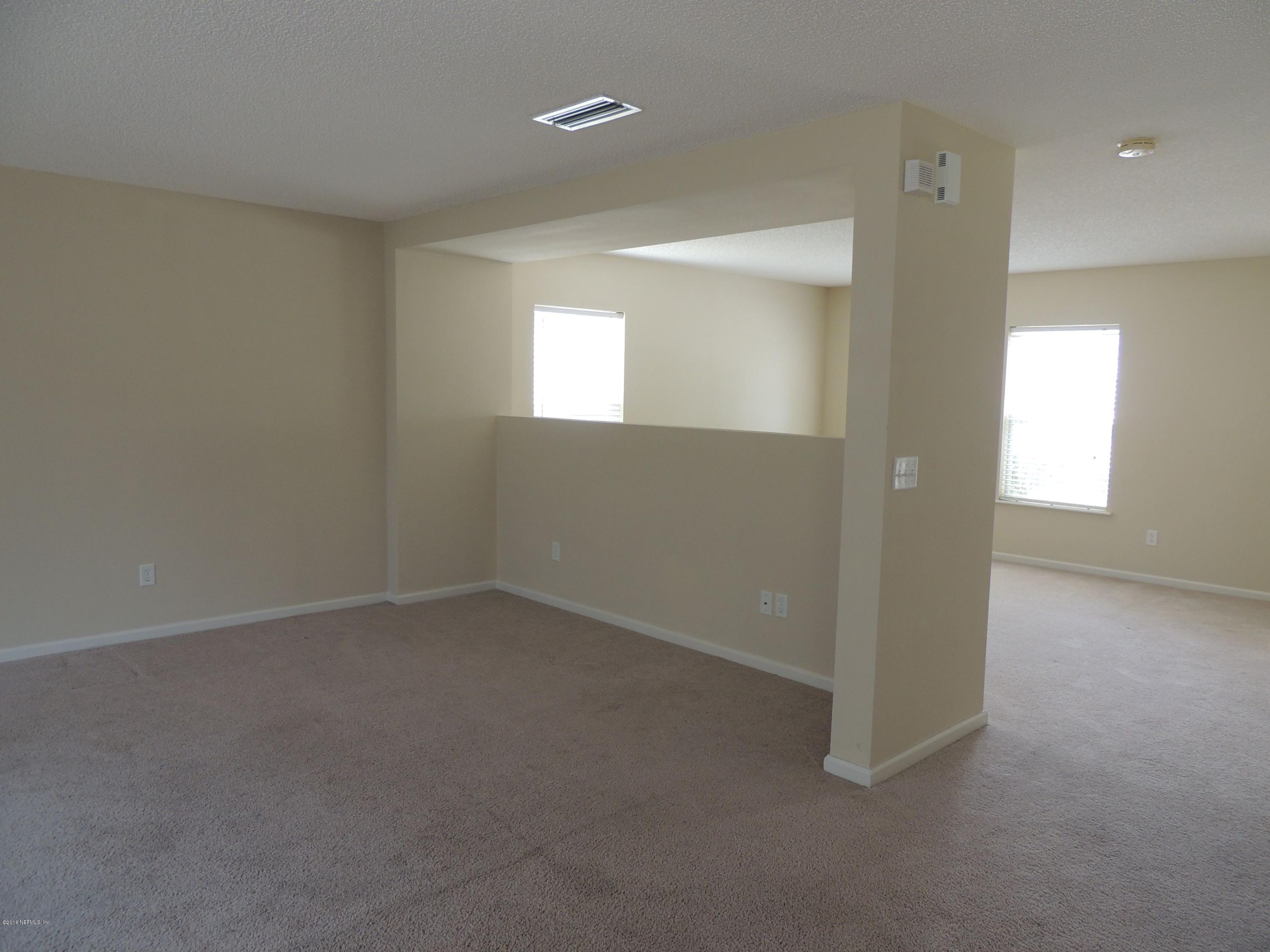 1179 Morning Light Road Jacksonville, FL 32218 - Photo 4 of 17 an empty room with windows