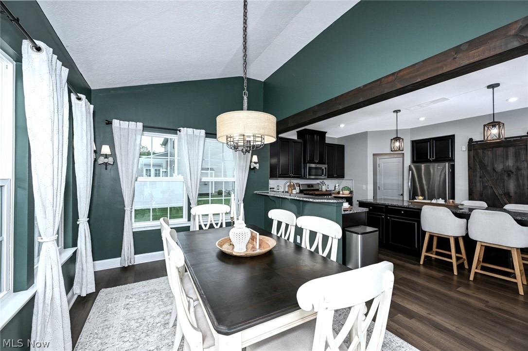 3021 Stonehurst Road Uniontown, OH 44685 - Photo 18 of 48 *MORNING ROOM W/WALLS OF WINDOWS, VAULTED CEILING, BEAMED ENTRY, CHANDELIER & ADDED SCONCE LIGHTING NEAR BREAKFAST BAR W/SLIDERS TO THE BACK YARD ~