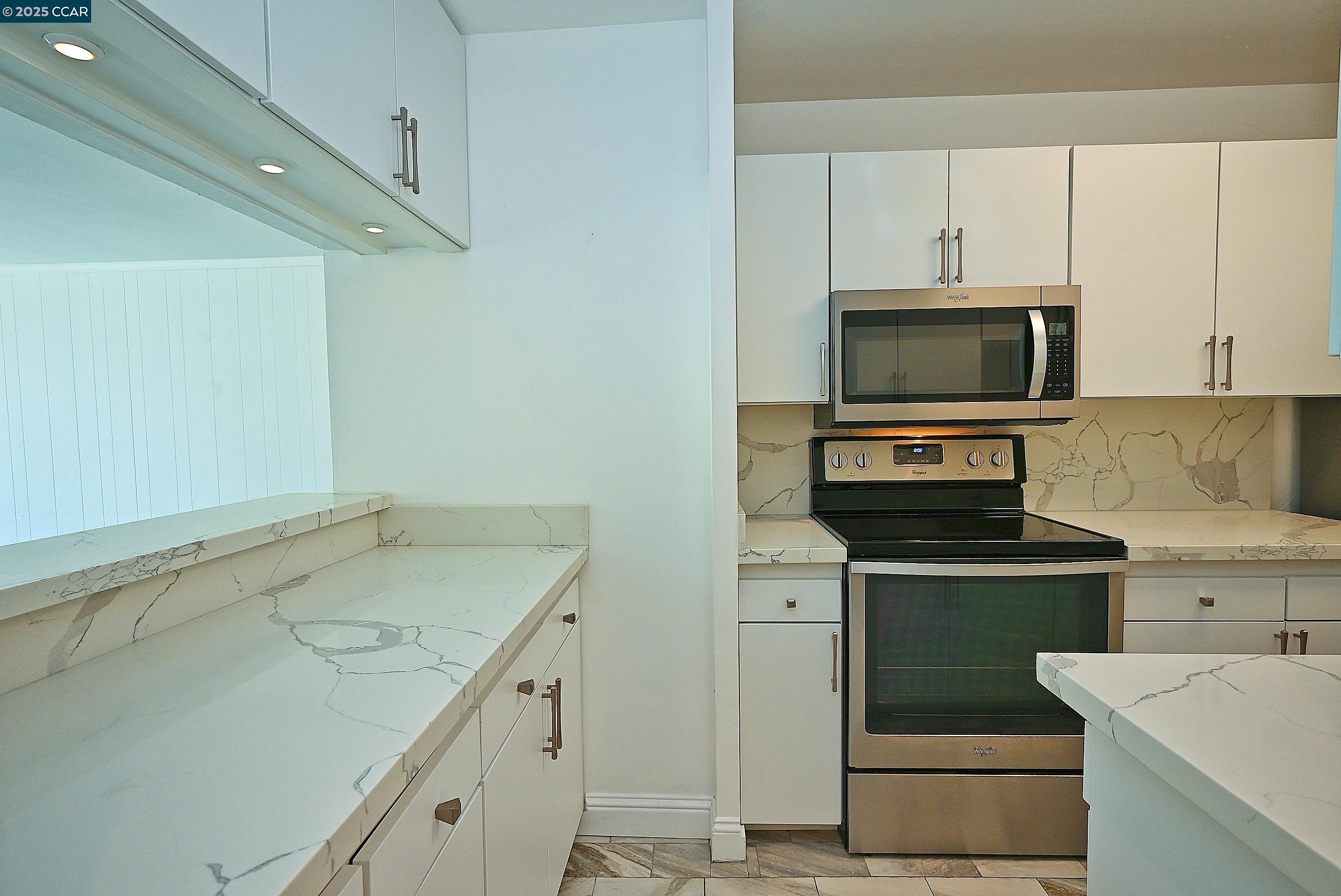 1425 Lakeside Drive, Unit 101 Oakland, CA 94612 - Photo 12 of 36 a kitchen with a sink stove and microwave