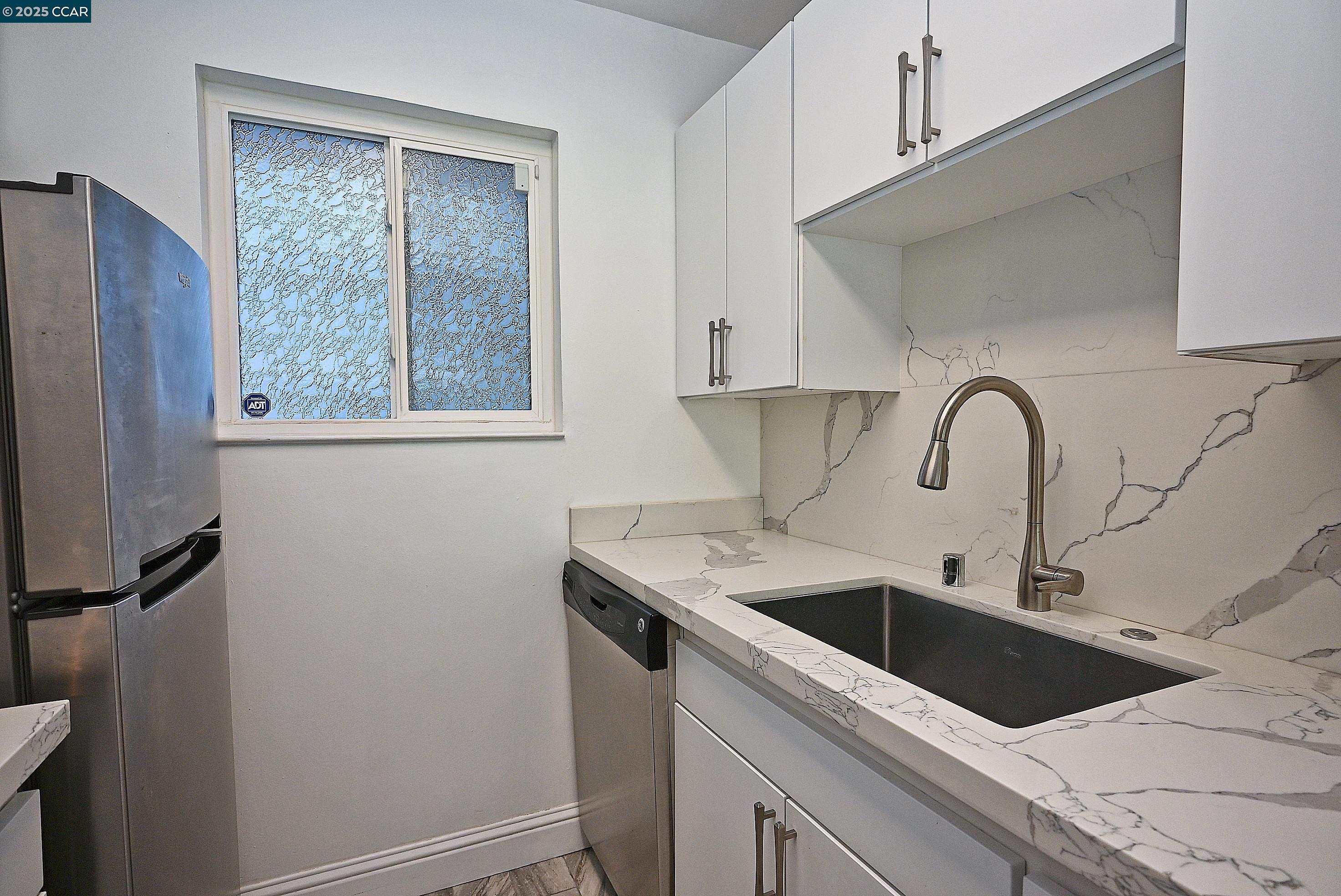 1425 Lakeside Drive, Unit 101 Oakland, CA 94612 - Photo 15 of 36 a view of a sink a refrigerator and window