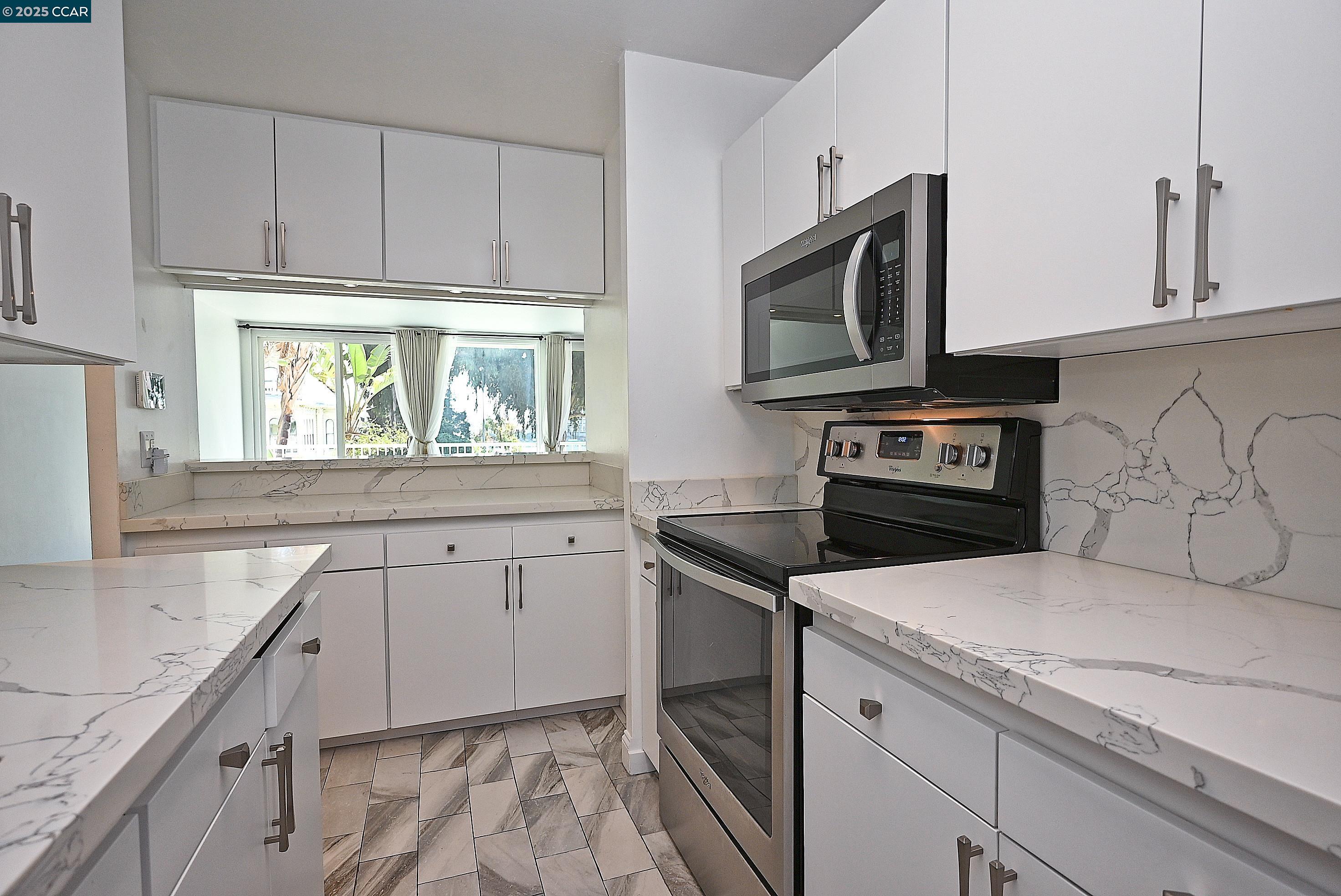 1425 Lakeside Drive, Unit 101 Oakland, CA 94612 - Photo 17 of 36 a kitchen with stainless steel appliances granite countertop a sink and a stove