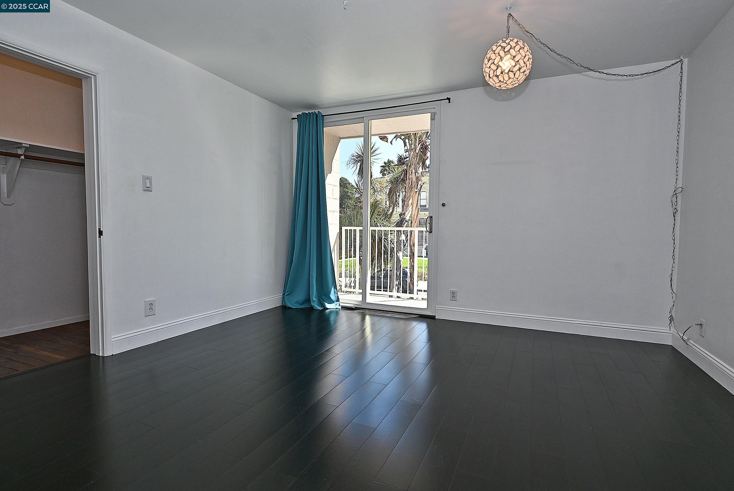 1425 Lakeside Drive, Unit 101 Oakland, CA 94612 - Photo 19 of 36 an empty room with wooden floor and windows