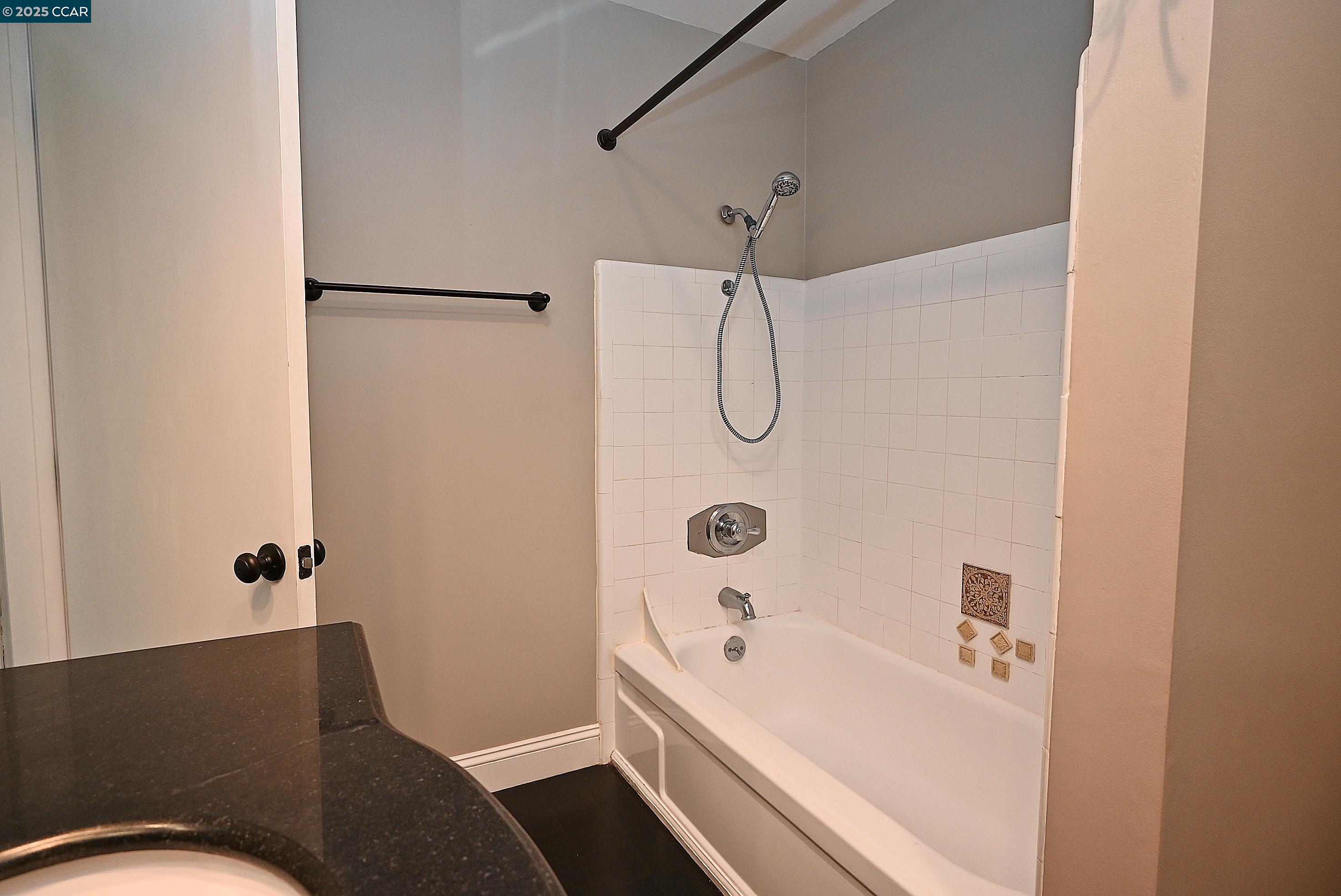 1425 Lakeside Drive, Unit 101 Oakland, CA 94612 - Photo 23 of 36 a bathroom with a bathtub and shower