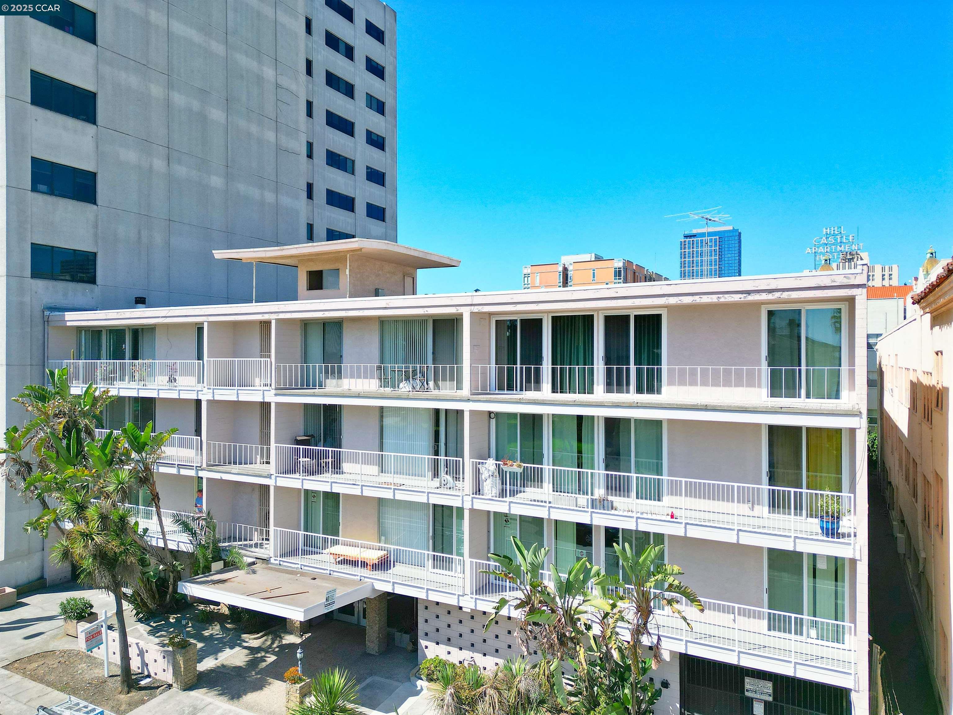 1425 Lakeside Drive, Unit 101 Oakland, CA 94612 - Photo 36 of 36 a front view of a building with a garden and seating