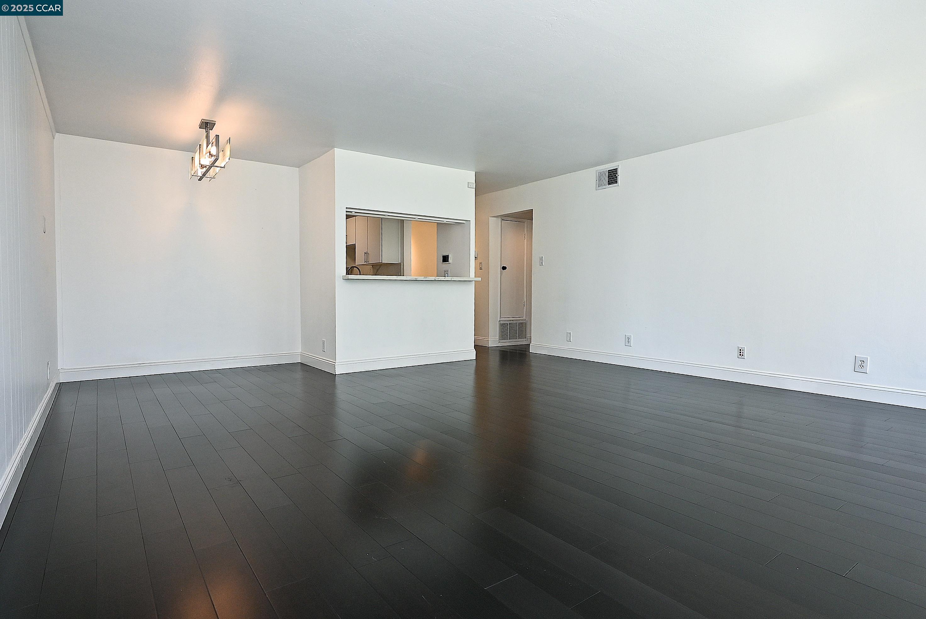 1425 Lakeside Drive, Unit 101 Oakland, CA 94612 - Photo 10 of 36 a view of empty room with wooden floor and fan