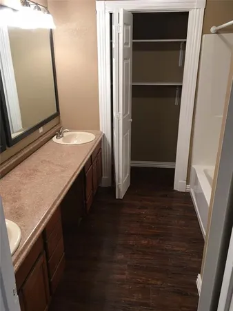 a bathroom with a double vanity sink and a mirror