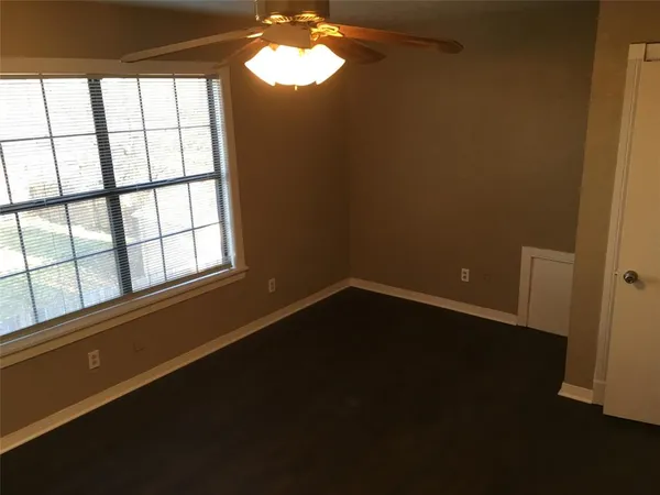 a view of wooden floor and windows in a room