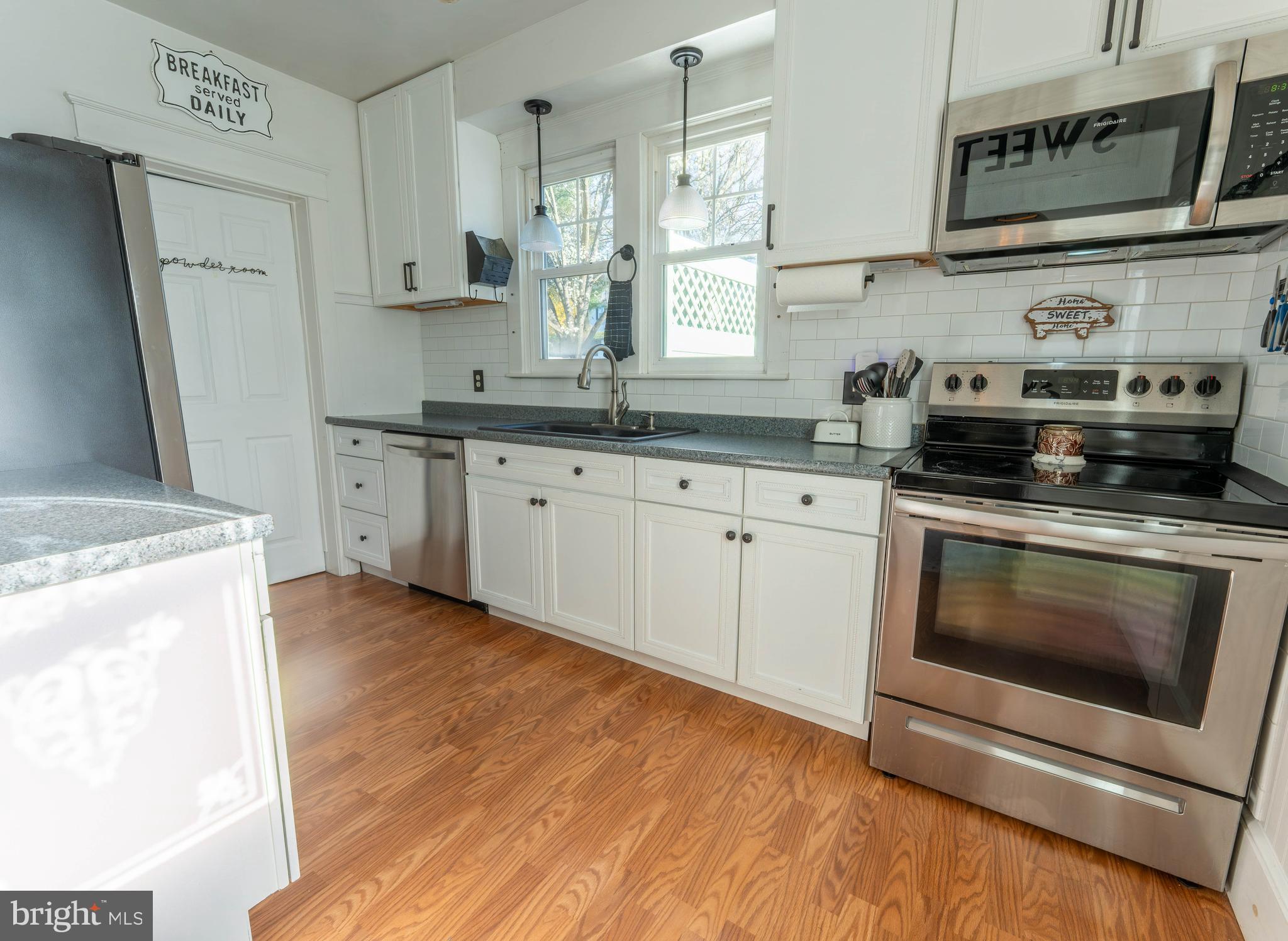 16 Main Street Felton, PA 17322 - Photo 13 of 34 a kitchen with stainless steel appliances granite countertop a stove a sink and a microwave