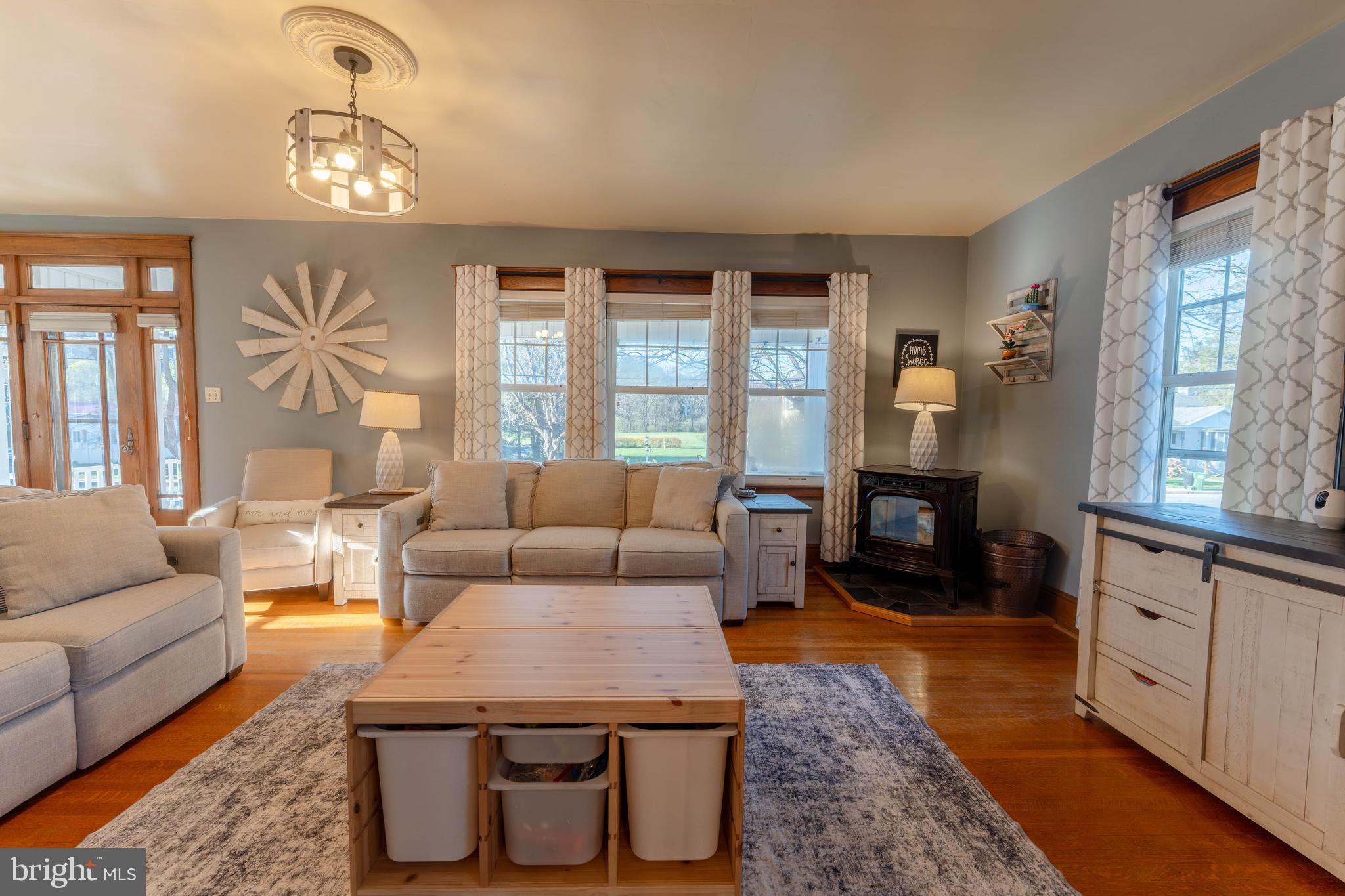 16 Main Street Felton, PA 17322 - Photo 10 of 34 a living room with furniture a fireplace and a chandelier