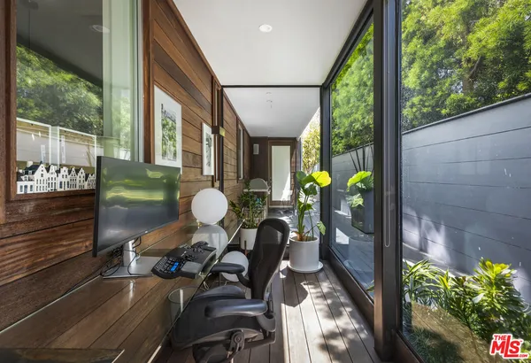 a view of a porch with chairs and backyard
