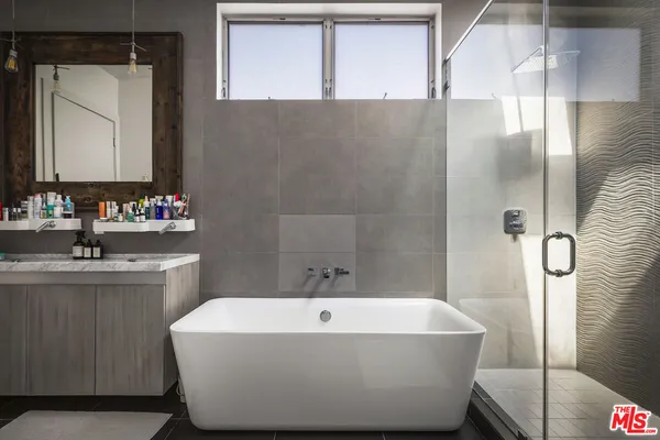 a white bath tub sitting next to a bathroom sink