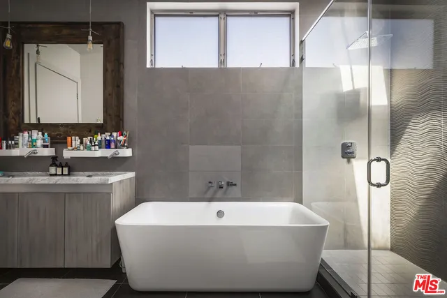 a white bath tub sitting next to a bathroom sink