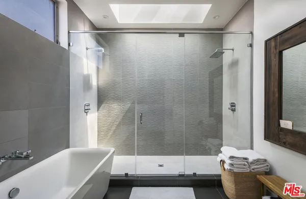 a bathroom with a bathtub and a shower