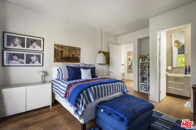 a bedroom with a bed next to a window