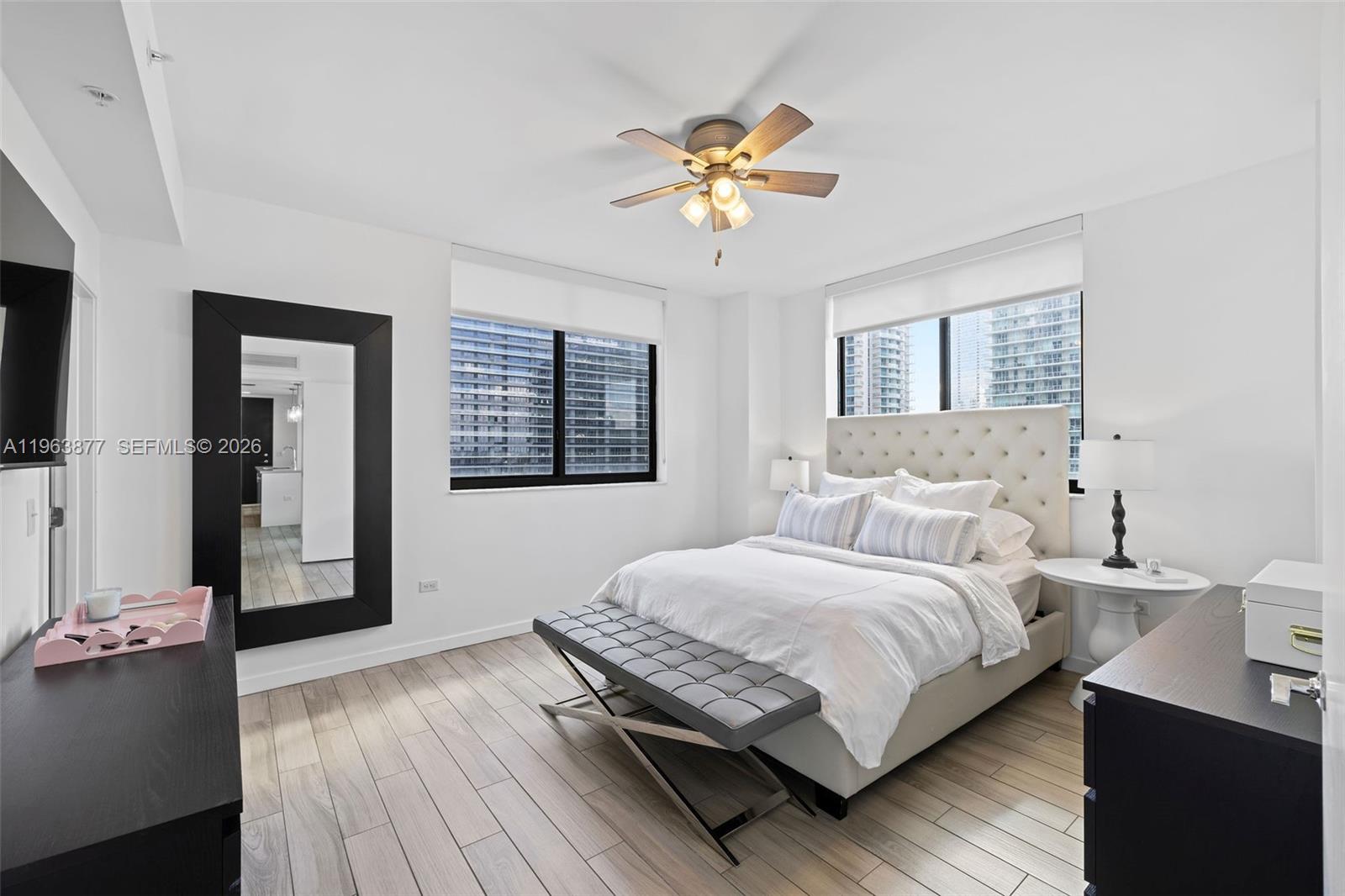 999 Southwest 1st Avenue, Unit 2303 Miami, FL 33130 - Photo 12 of 44 a bedroom with a bed and a chandelier