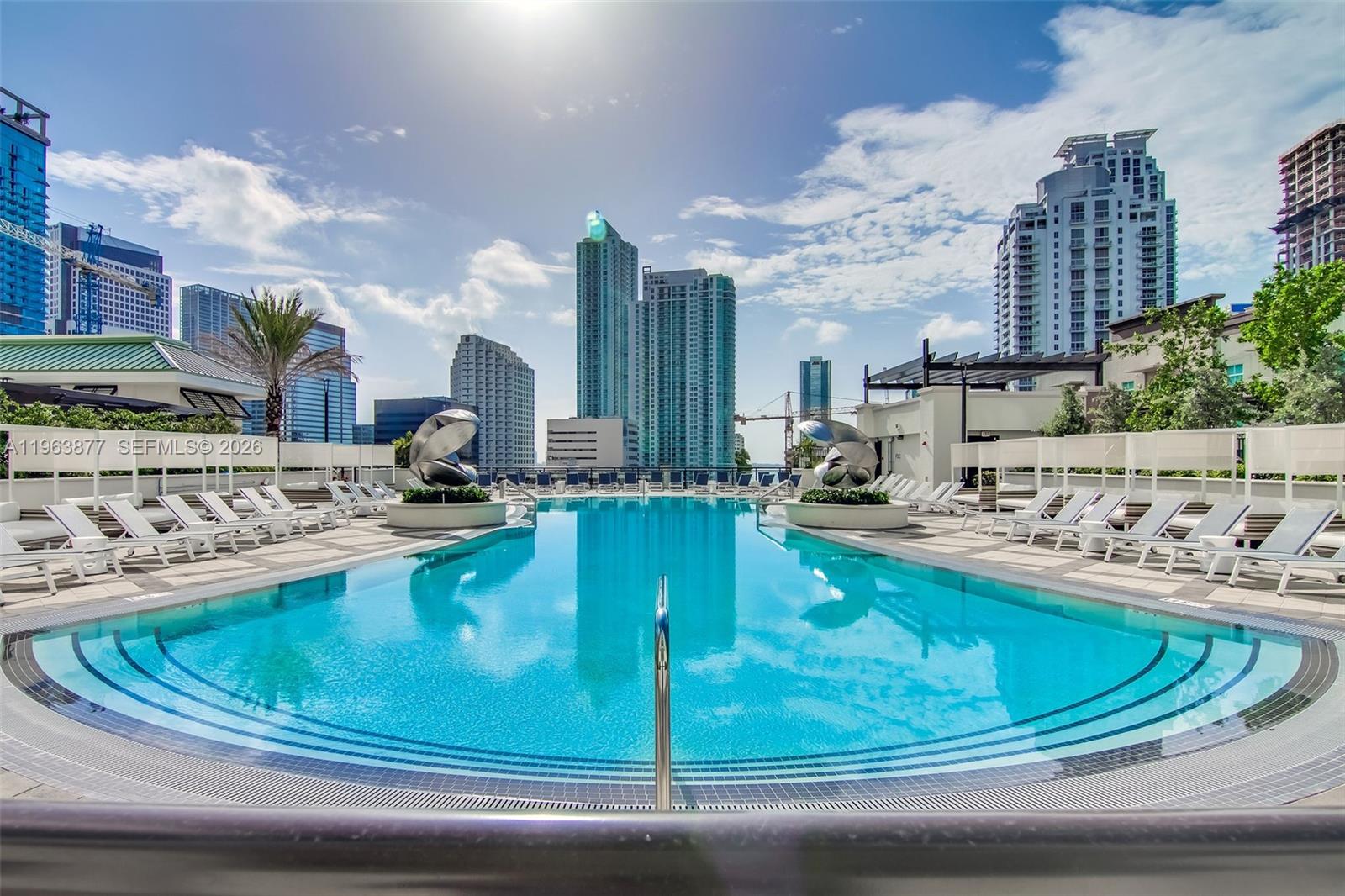 999 Southwest 1st Avenue, Unit 2303 Miami, FL 33130 - Photo 18 of 44 a view of a swimming pool with a sitting area