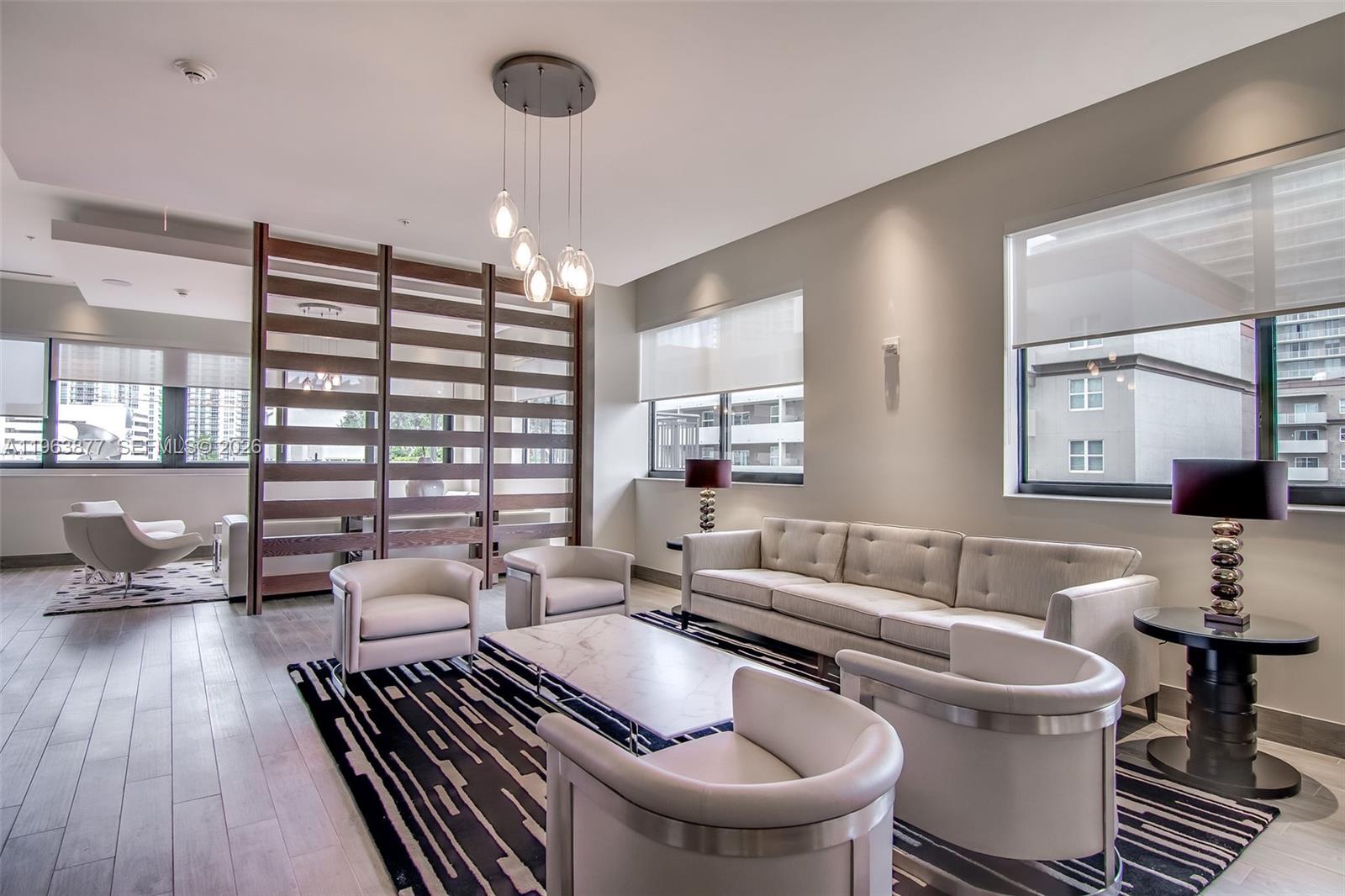 999 Southwest 1st Avenue, Unit 2303 Miami, FL 33130 - Photo 25 of 44 a living room with furniture and a chandelier